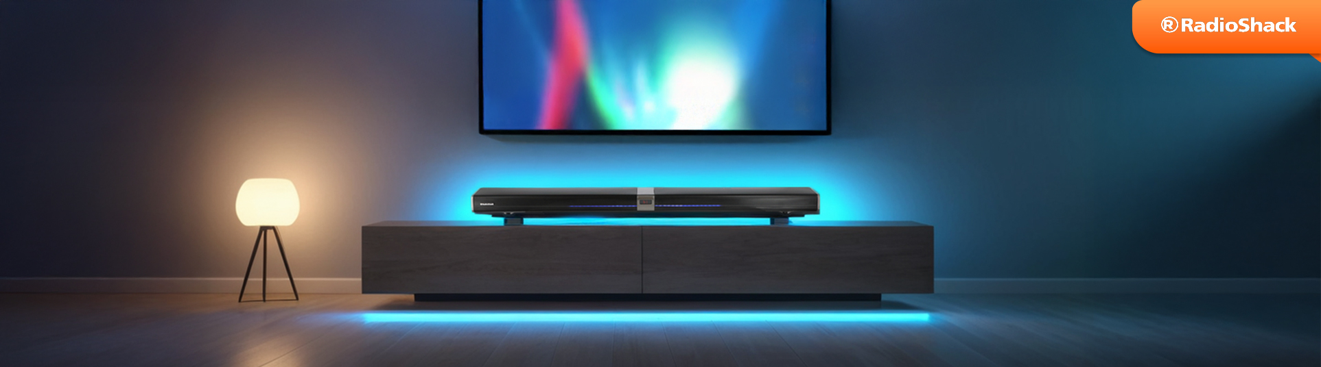 barra de sonido negra emitiendo señal de audio de una pantalla led y recargada sobre mueble color obscuro decorado con luces neon
