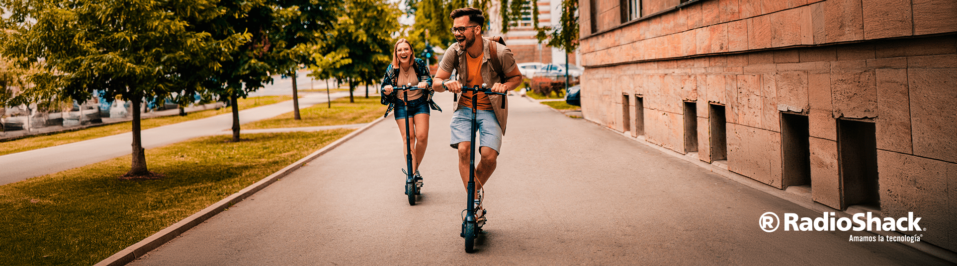 un hombre y una mujer van paseando en scooters electricos de la marca honeywhale mientras se van divirtiendo en el trayecto sonriendo porque los acaban de estrenar.